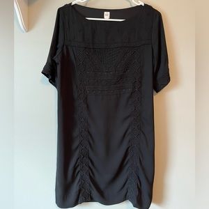 Black oversized dress with stitching detail.